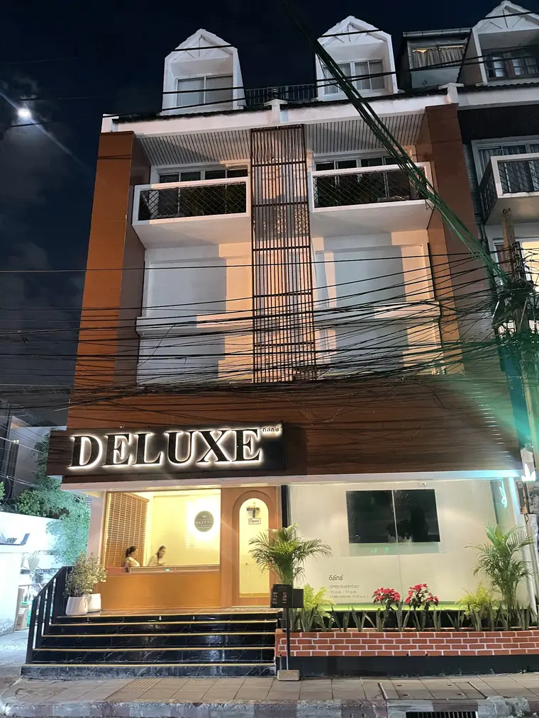 Photo: Google Maps via Google Maps Deluxe Massage: building with the lit sign at night